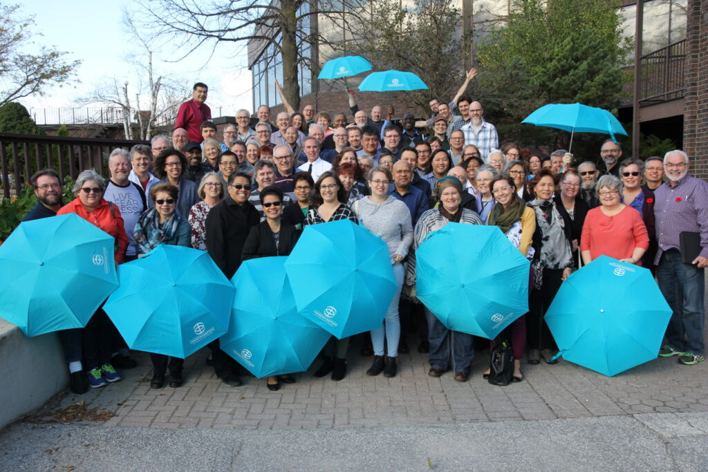 Pastors at NCPO, showing off their CBOQ-branded umbrellas