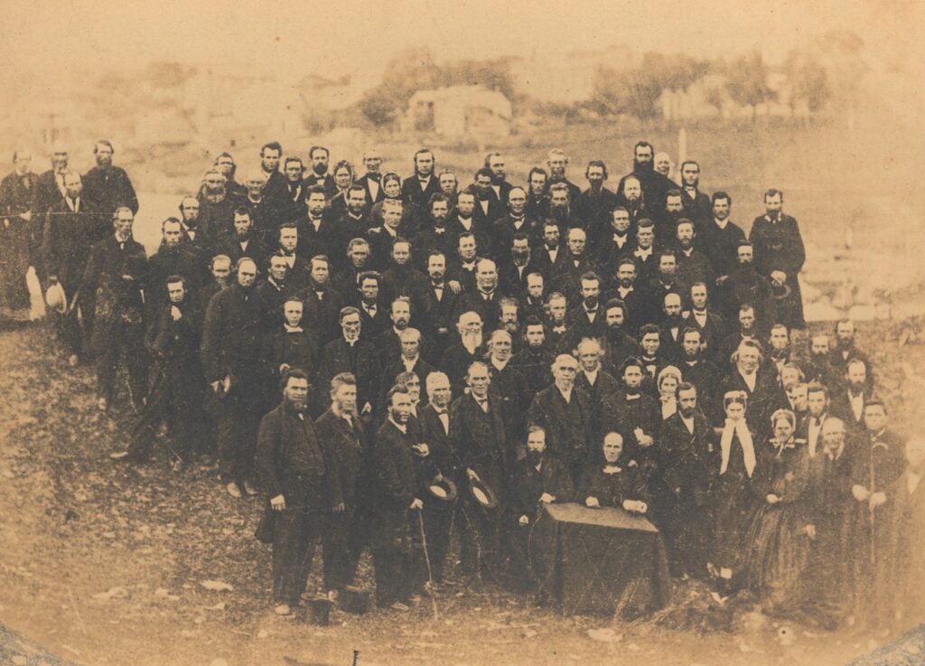 Large sepia group portrait of Baptists gathered outdoors in Ingersoll, Ontario, circa 1867