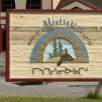 Mistissini Lodge wooden sign with beaver, pines, and Cree syllabics