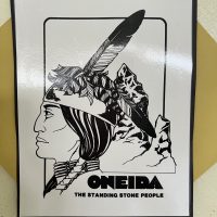 Black-and-white poster: profile with feather and mountains; text “ONEIDA—THE STANDING STONE PEOPLE.”